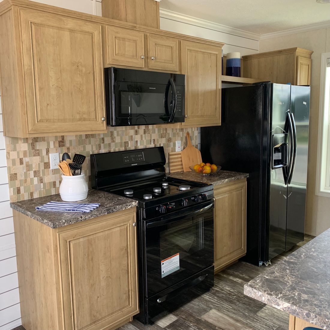 The LAWRENCE 7016-707 Kitchen. This Manufactured Mobile Home features 3 bedrooms and 2 baths.