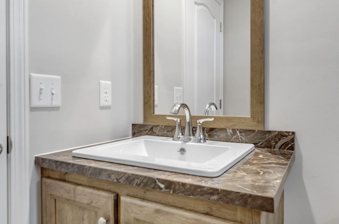 The MIFFLIN 6028-942 Guest Bathroom. This Manufactured Mobile Home features 3 bedrooms and 2 baths.